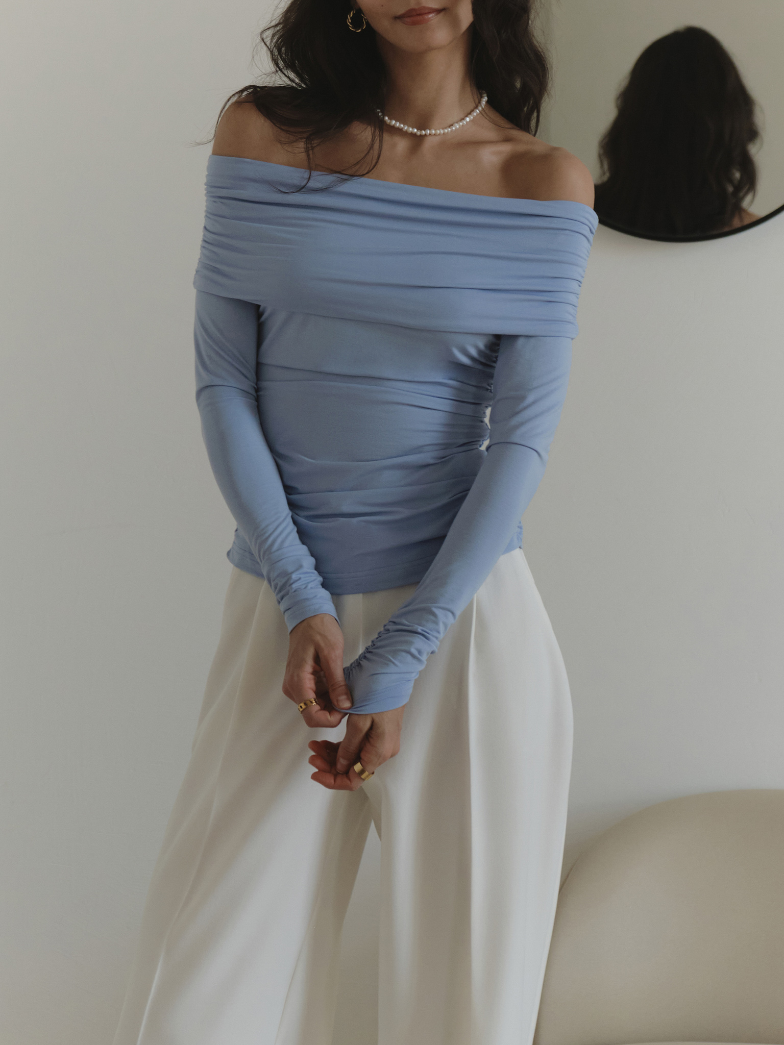 Top with open shoulders and draping on bodice