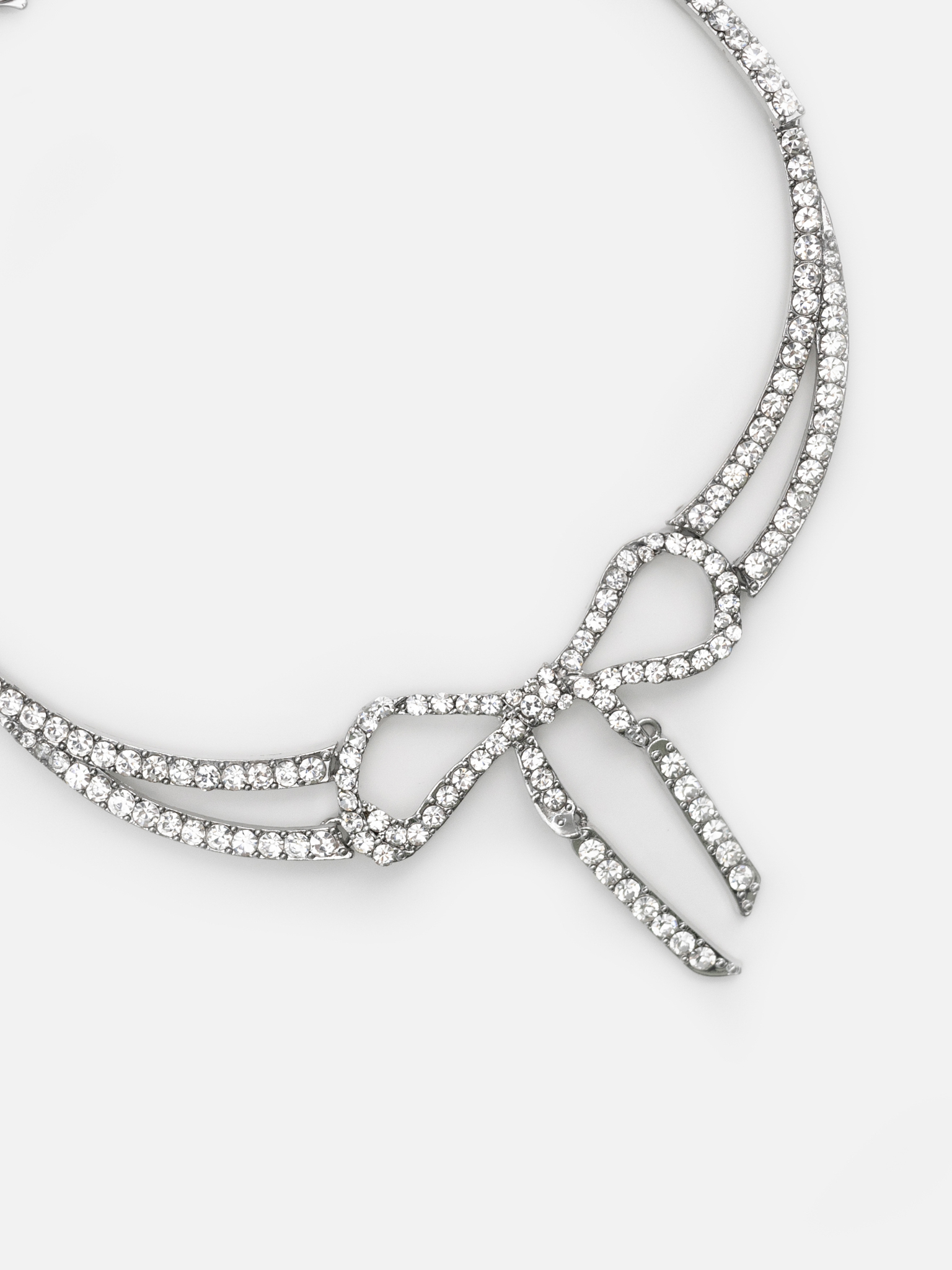 Silvertone necklace with rhinestone bow