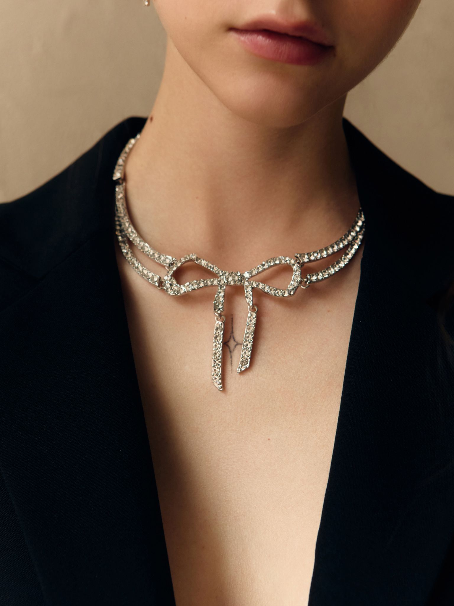 Silvertone necklace with rhinestone bow