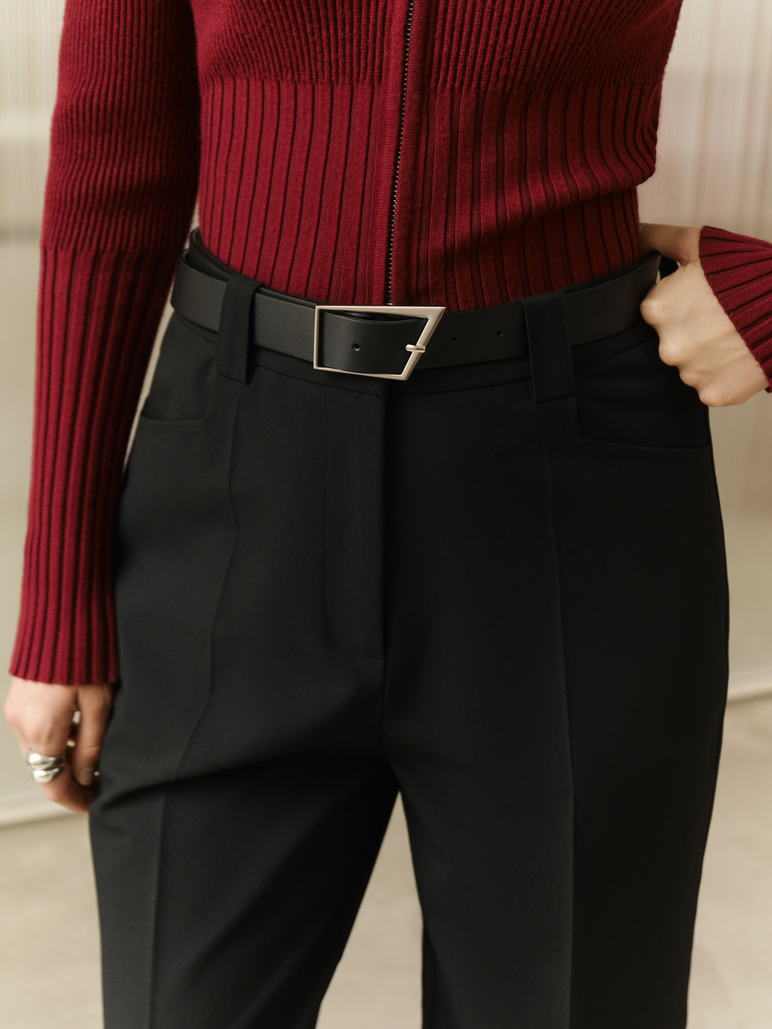 Straight suiting trousers with stitched creases and a belt