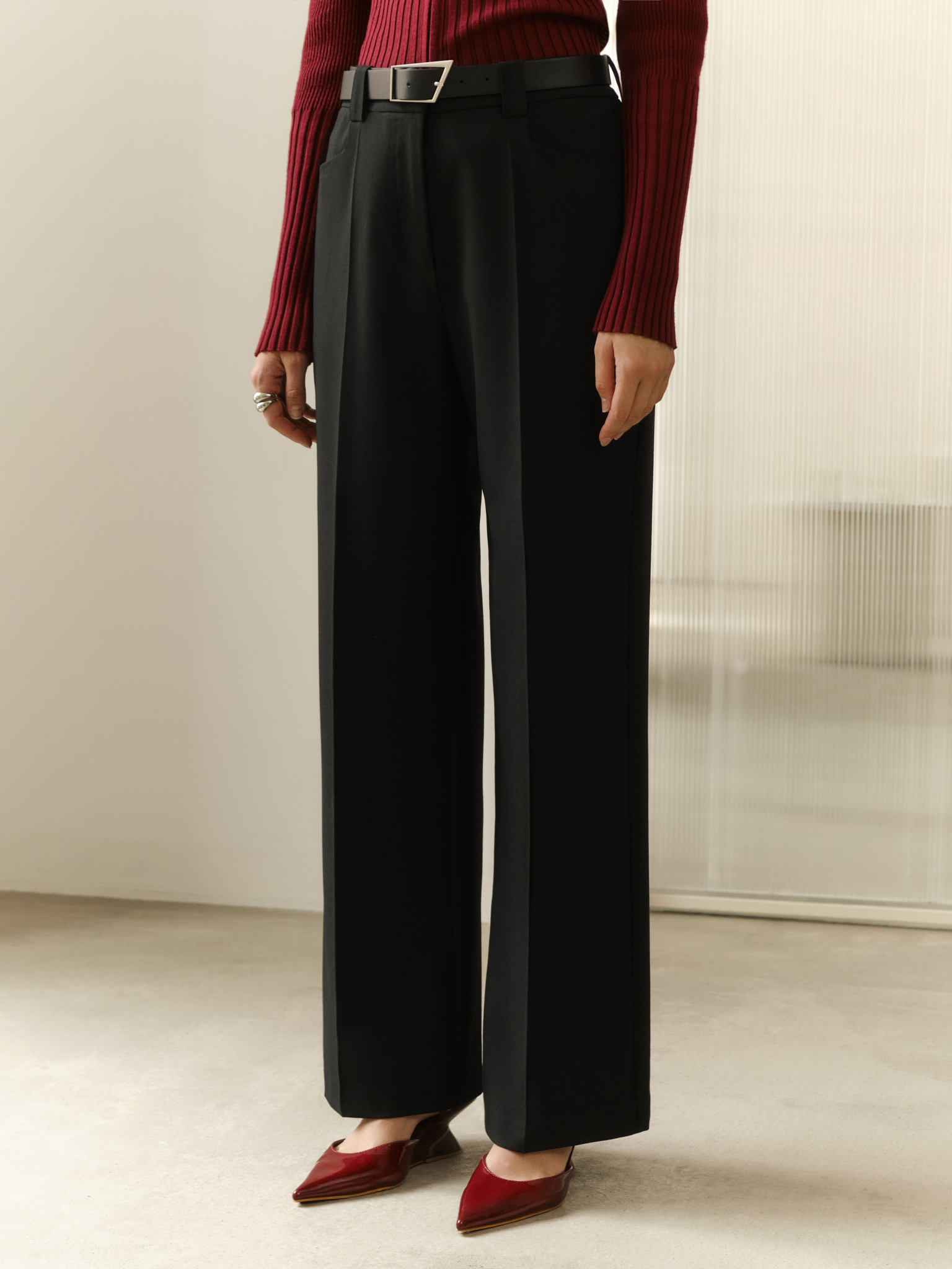 Straight suiting trousers with stitched creases and a belt