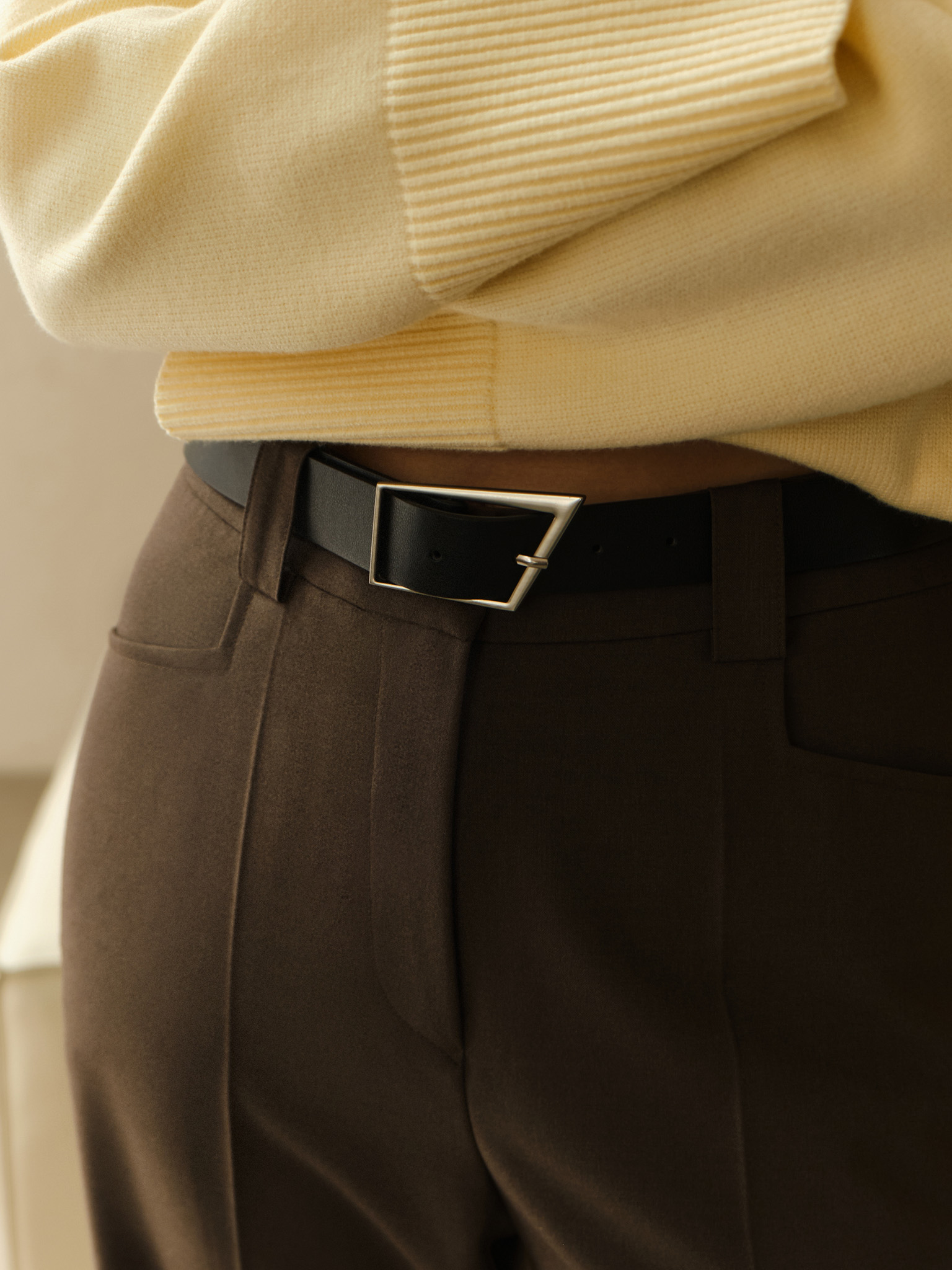 Straight suiting trousers with stitched creases and a belt