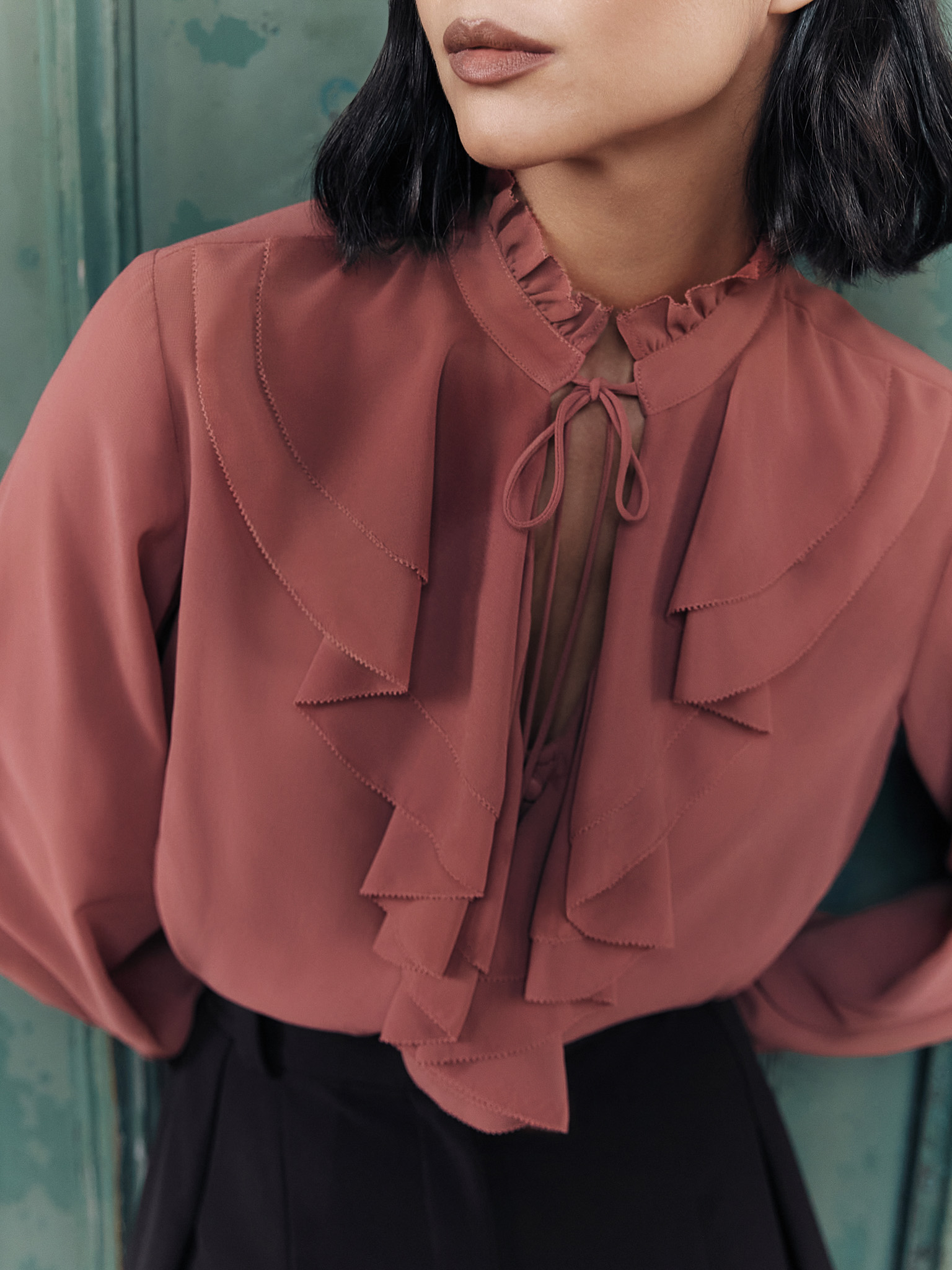 Light blouse with flounces and ties at the collar