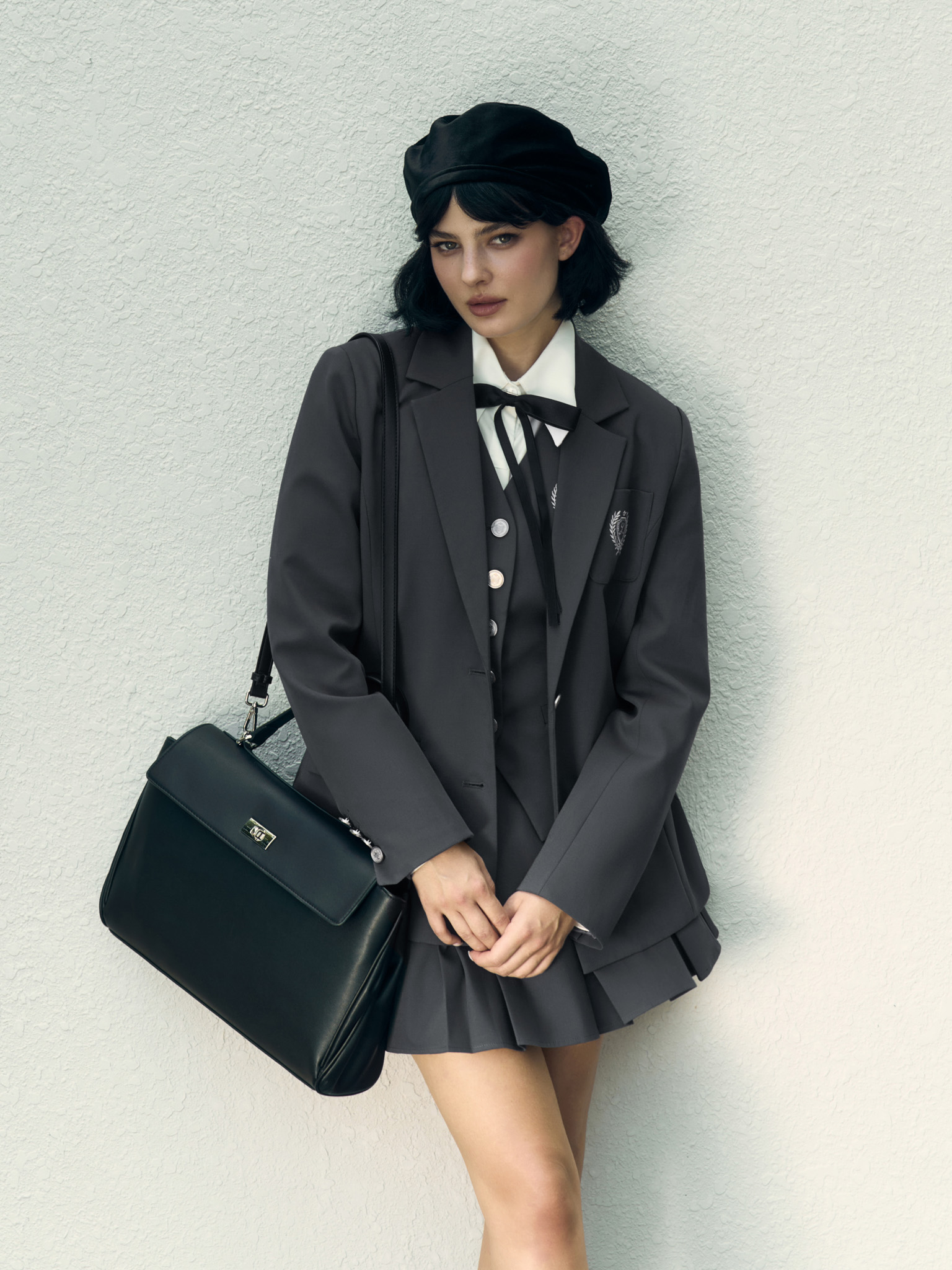 Mini pleated skirt with metal buttons on the waistband