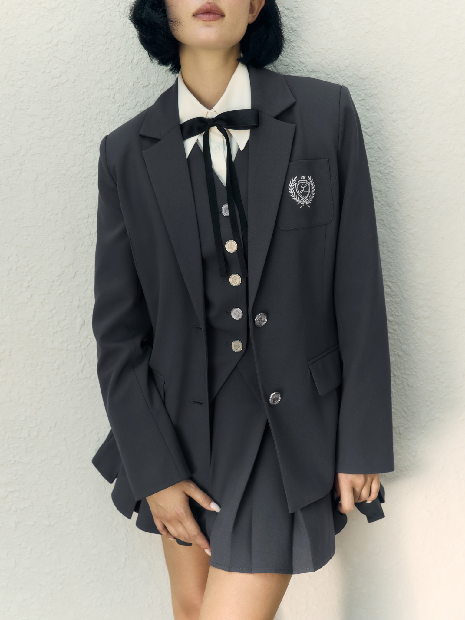 Mini pleated skirt with metal buttons on the waistband