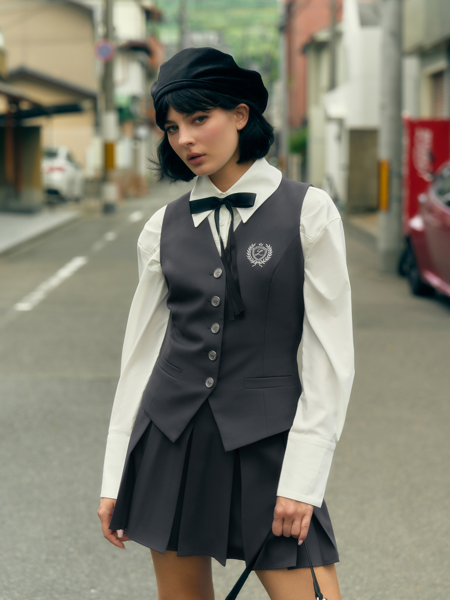 Mini pleated skirt with metal buttons on the waistband