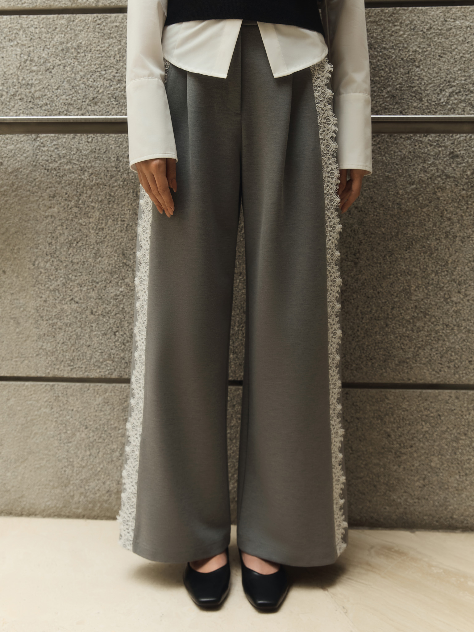 Loose trousers with lace inserts at the sides