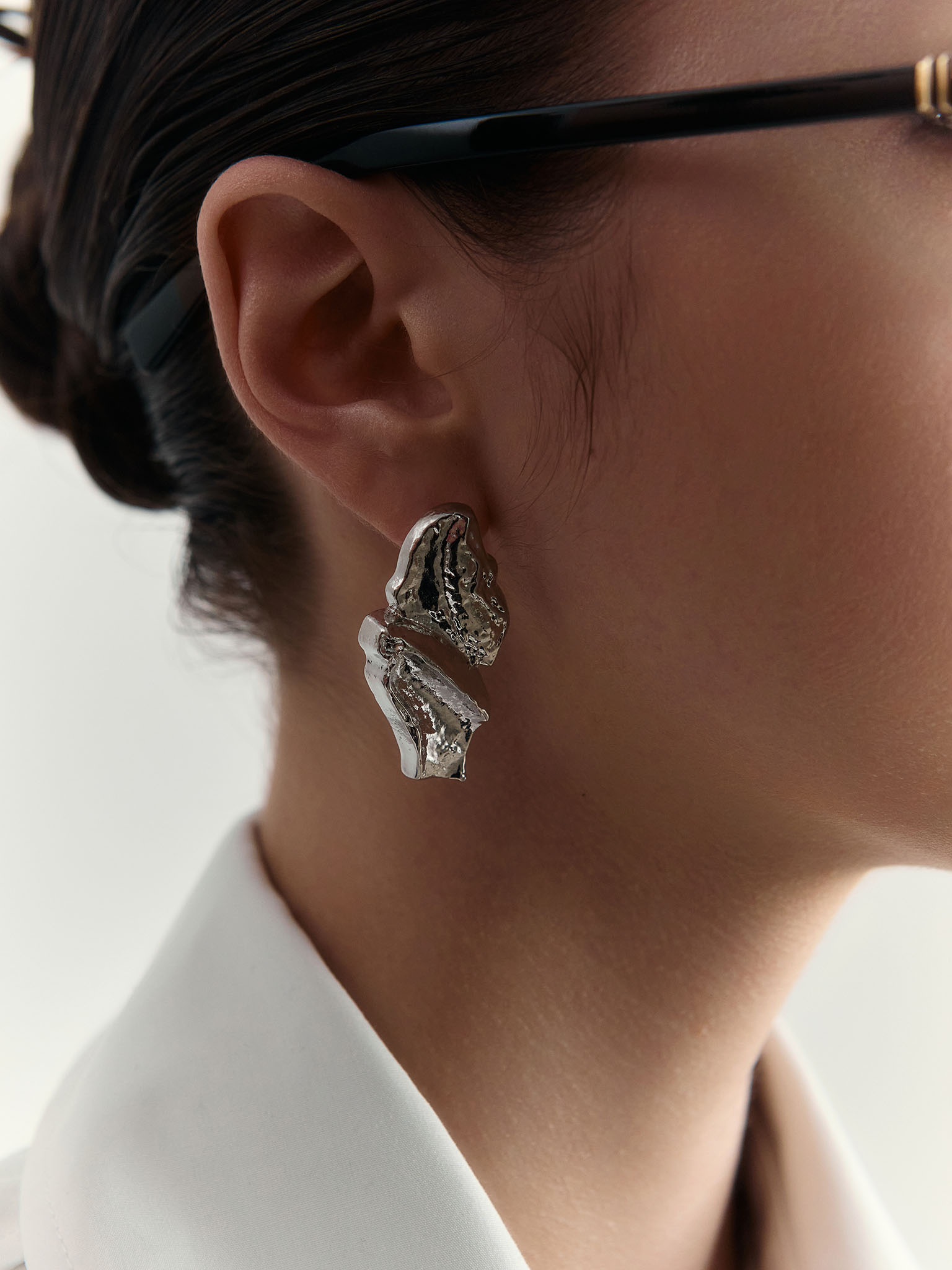 Large stud earrings in crumpled metal