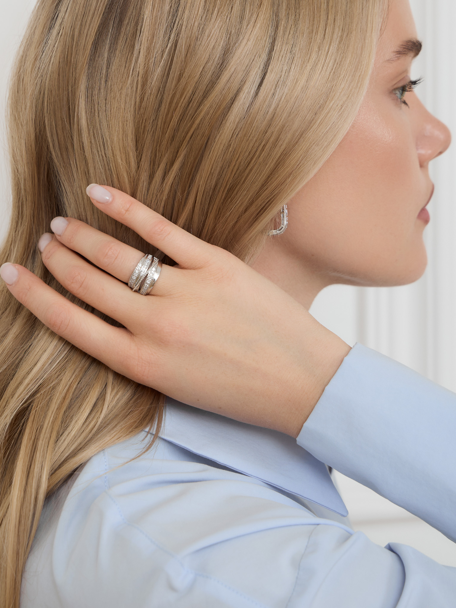 Multi-level silvertone ring with rhinestones