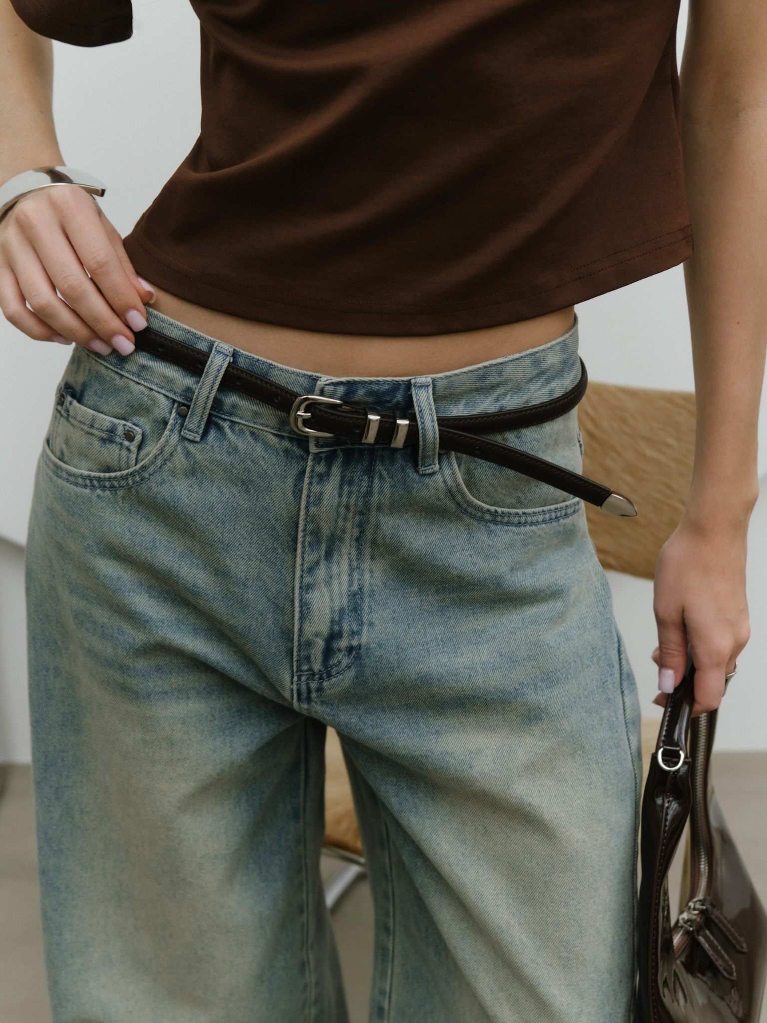 Slim leather belt with metal decorations