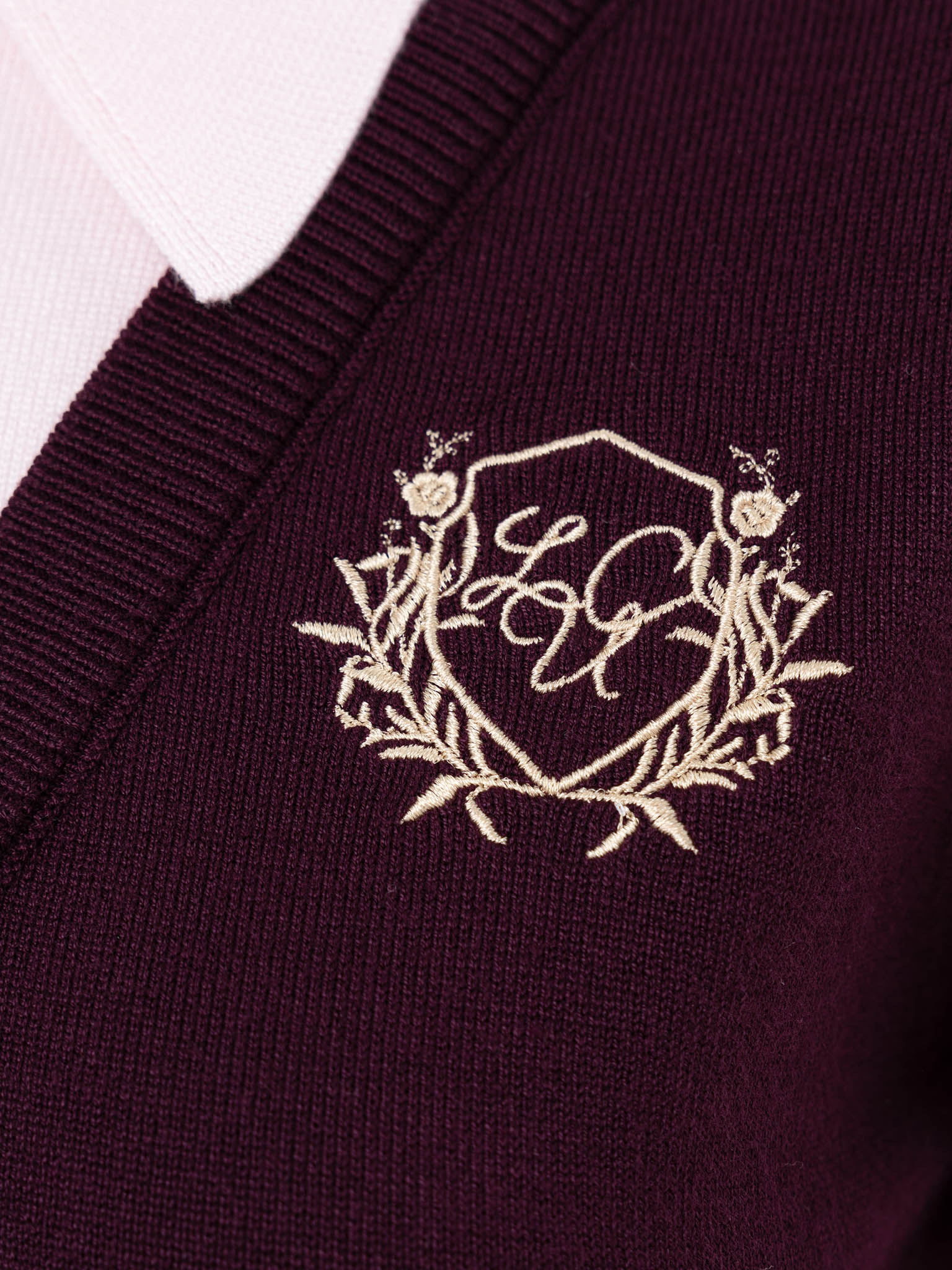 Knitted polo with contrasting vest and embroidery
