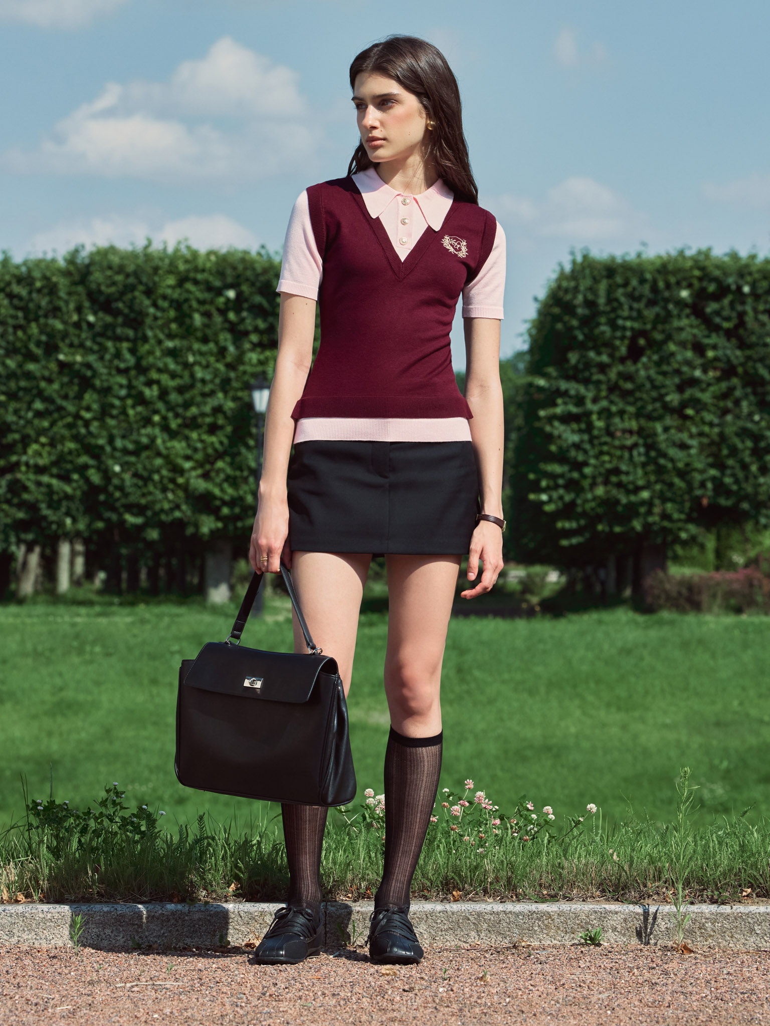 Knitted polo with contrasting vest and embroidery