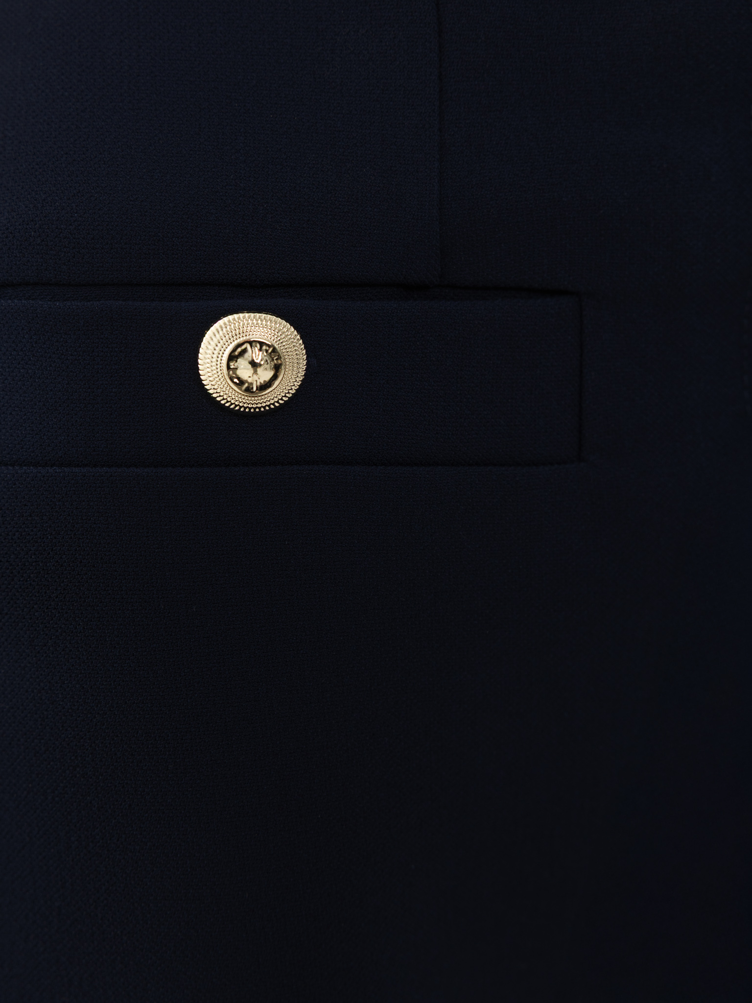 Mid-rise trousers with front creases and oversized buttons
