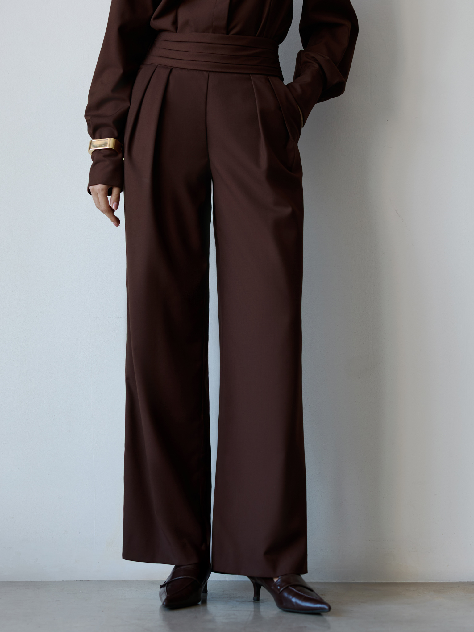 Loose trousers with wide draped belt
