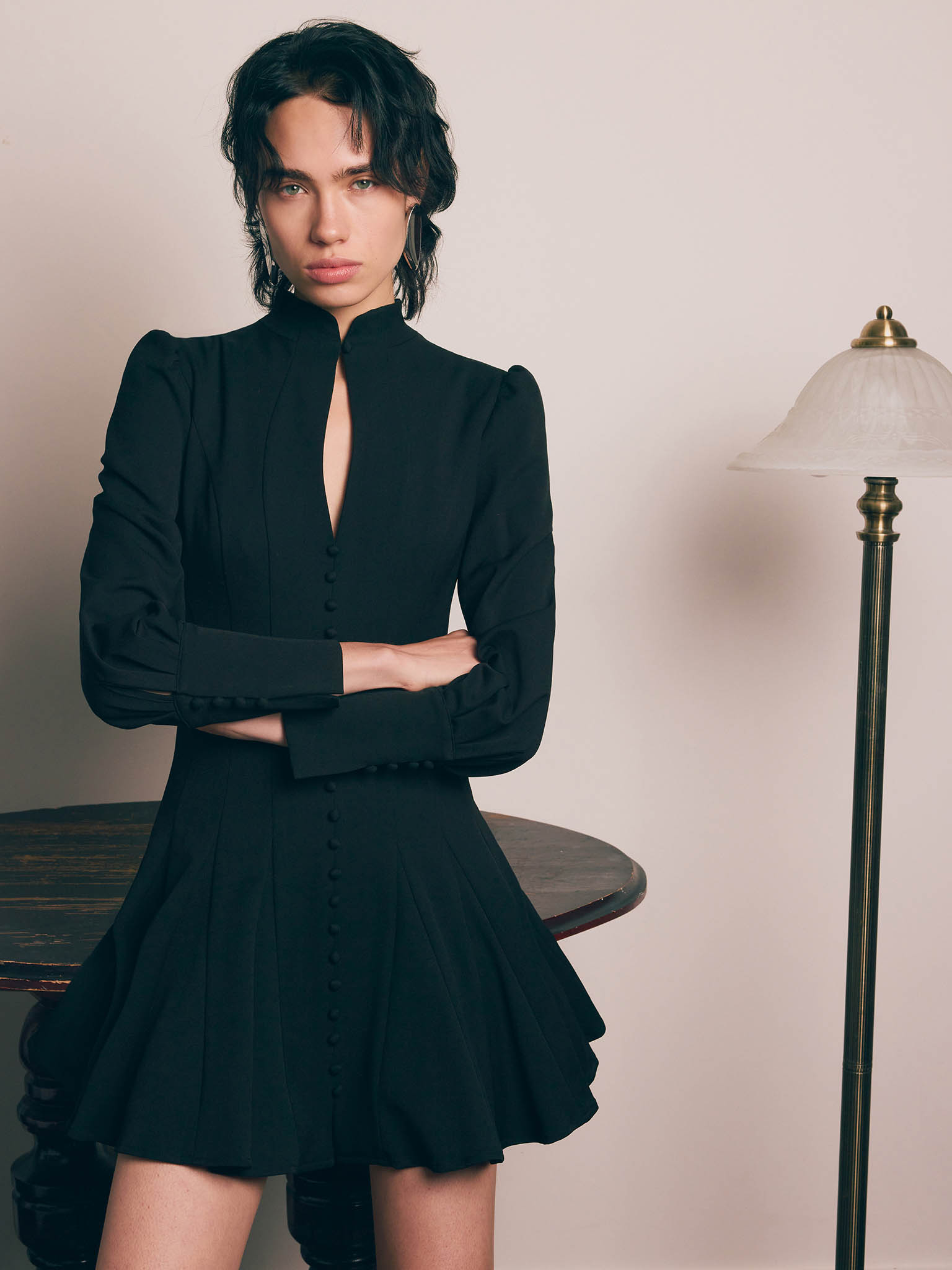 Fitted mini dress with shaped neckline and small buttons