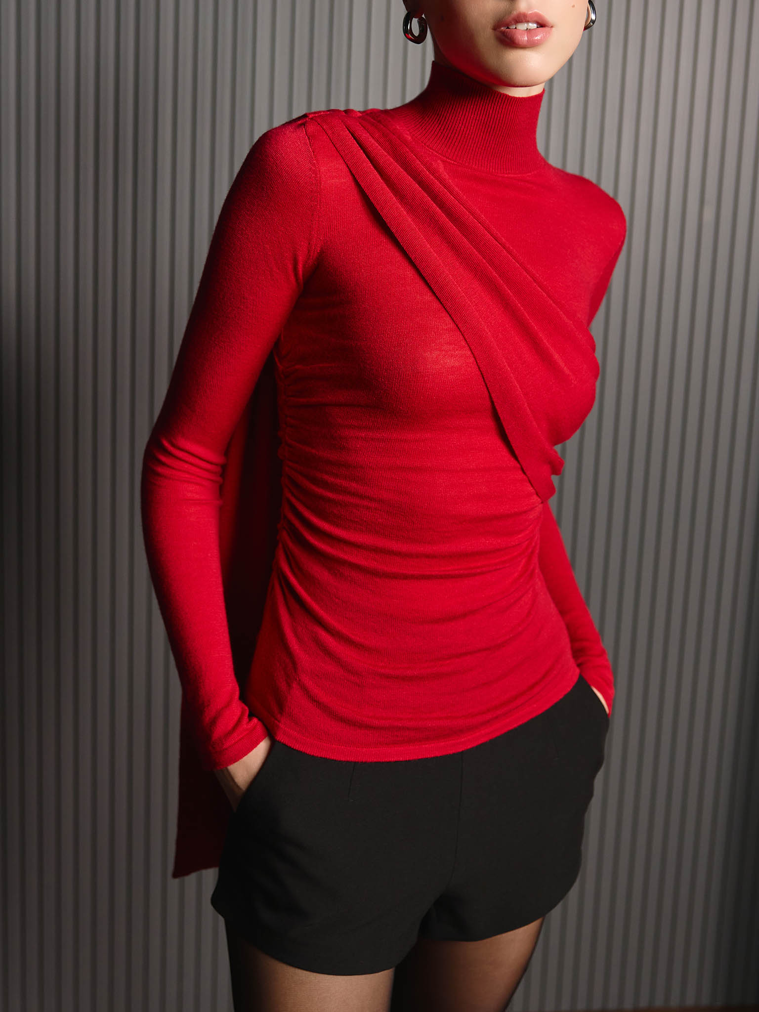 Turtleneck with diagonal drapery on the shoulder