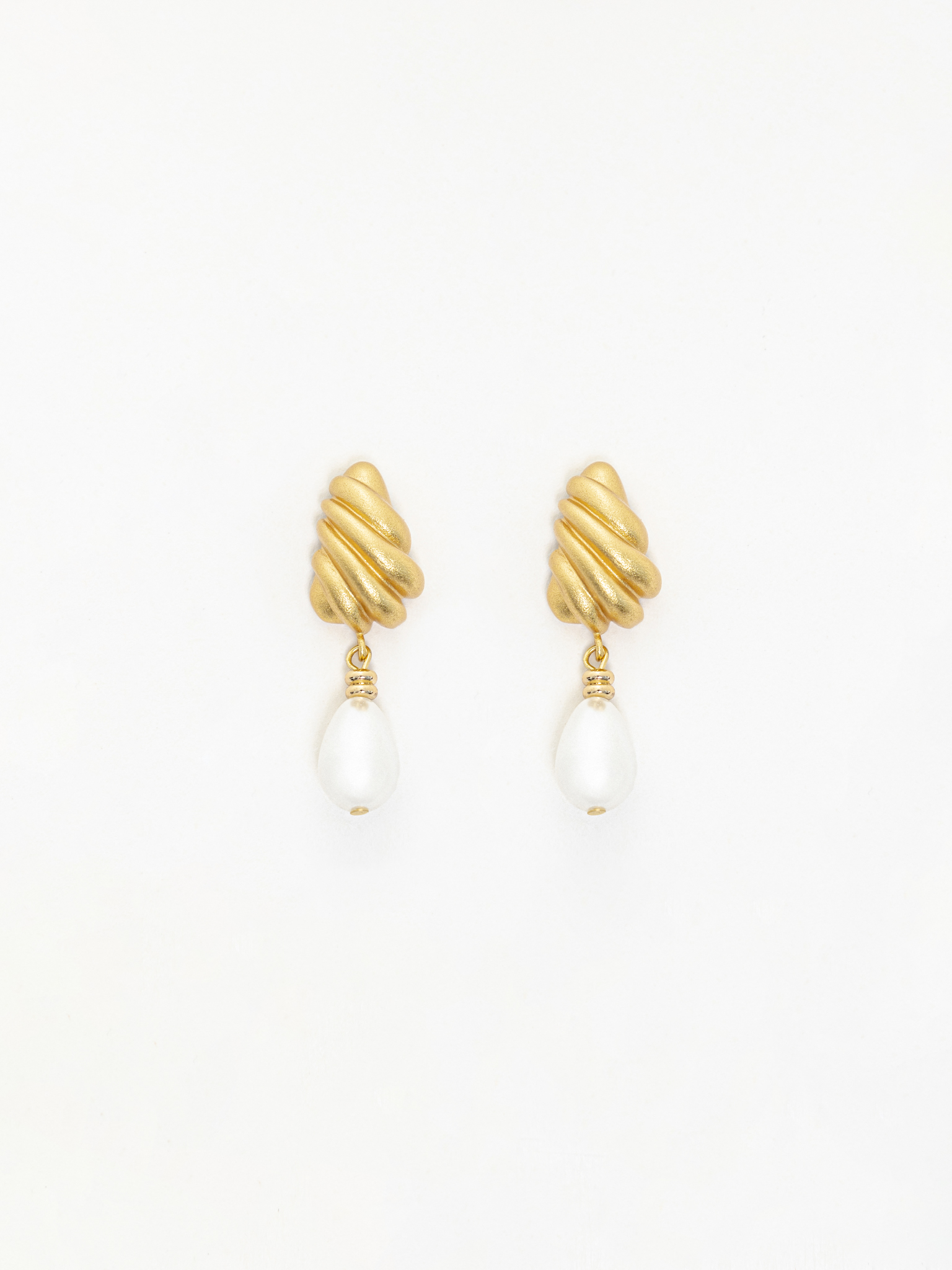 Stud earrings with intricate designs and teardrop pendants