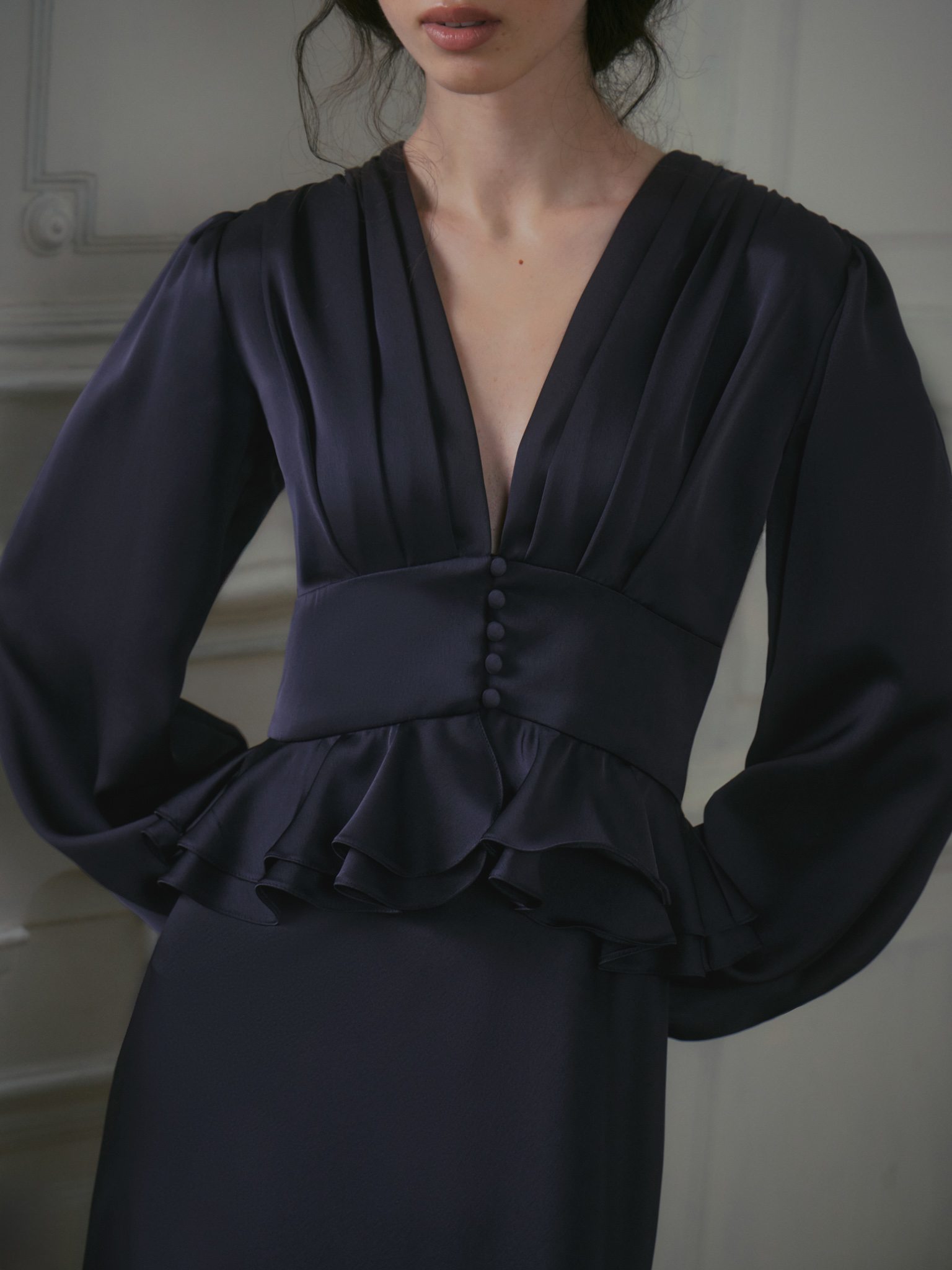Satin midi dress with a voluminous peplum