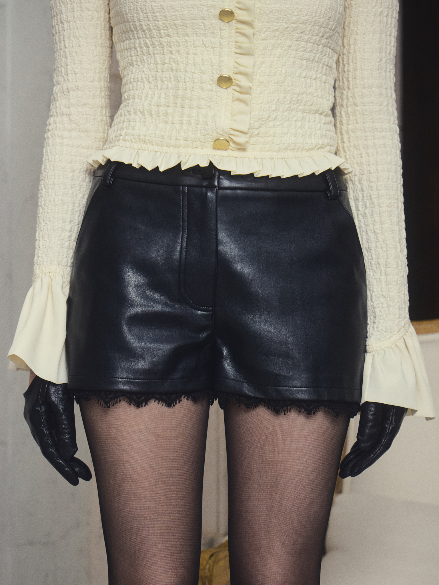 Mini eco-leather shorts with lace trim