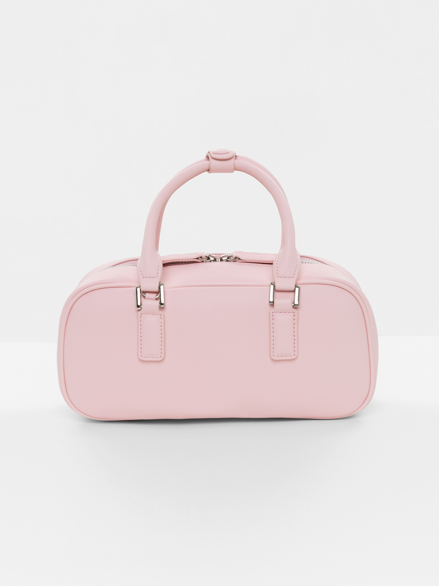 Rigid-shaped bag with short handles and a strap