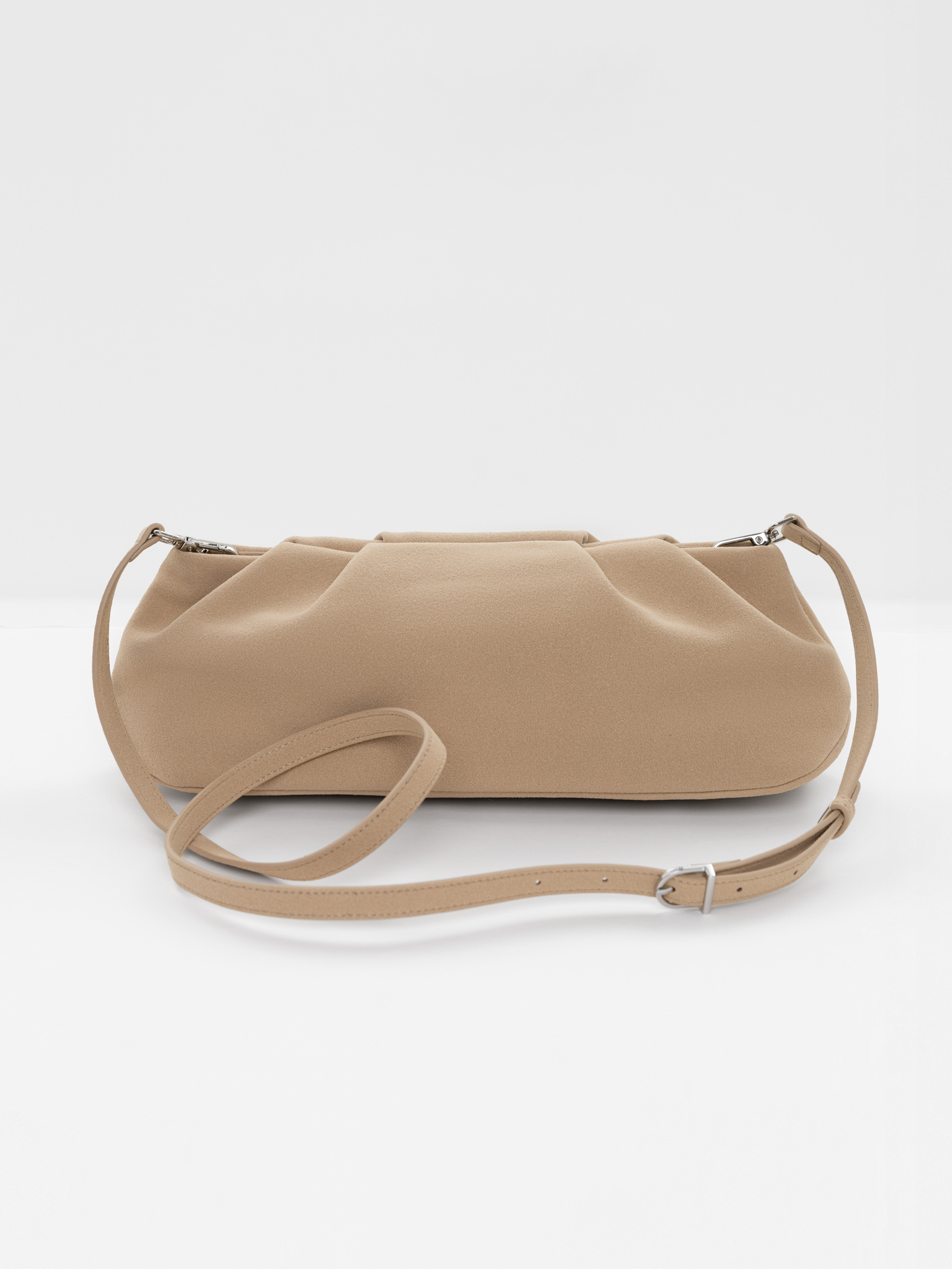 Voluminous eco-leather clutch bag with a thin strap