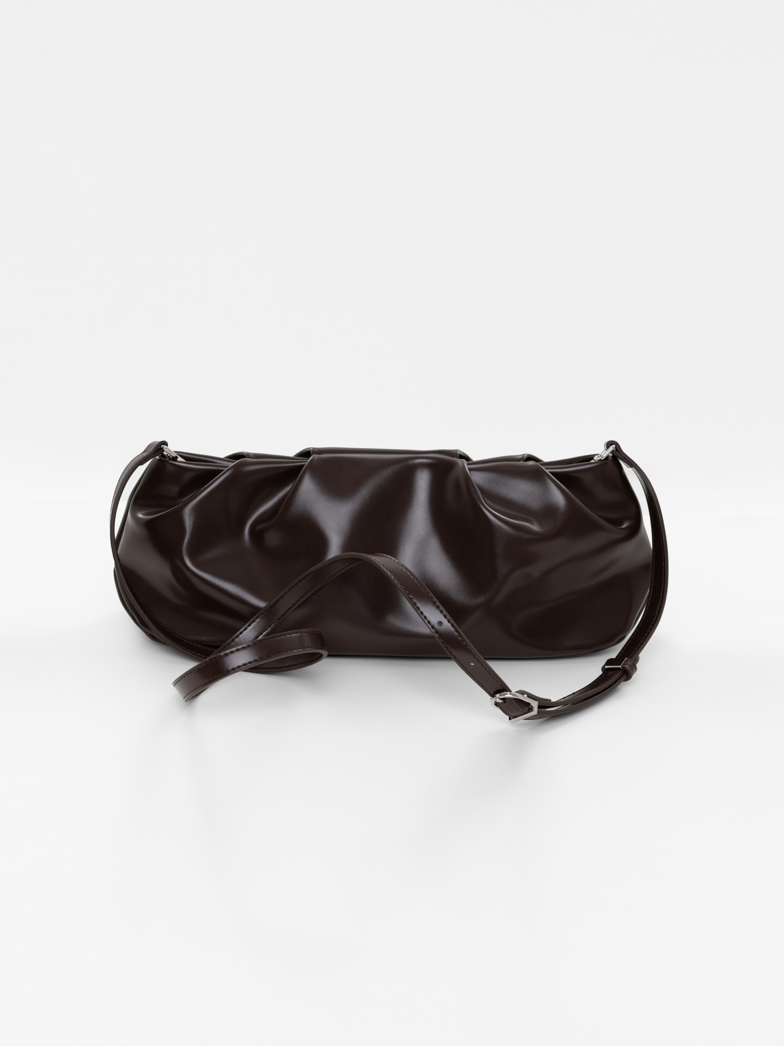 Voluminous eco-leather clutch bag with a thin strap