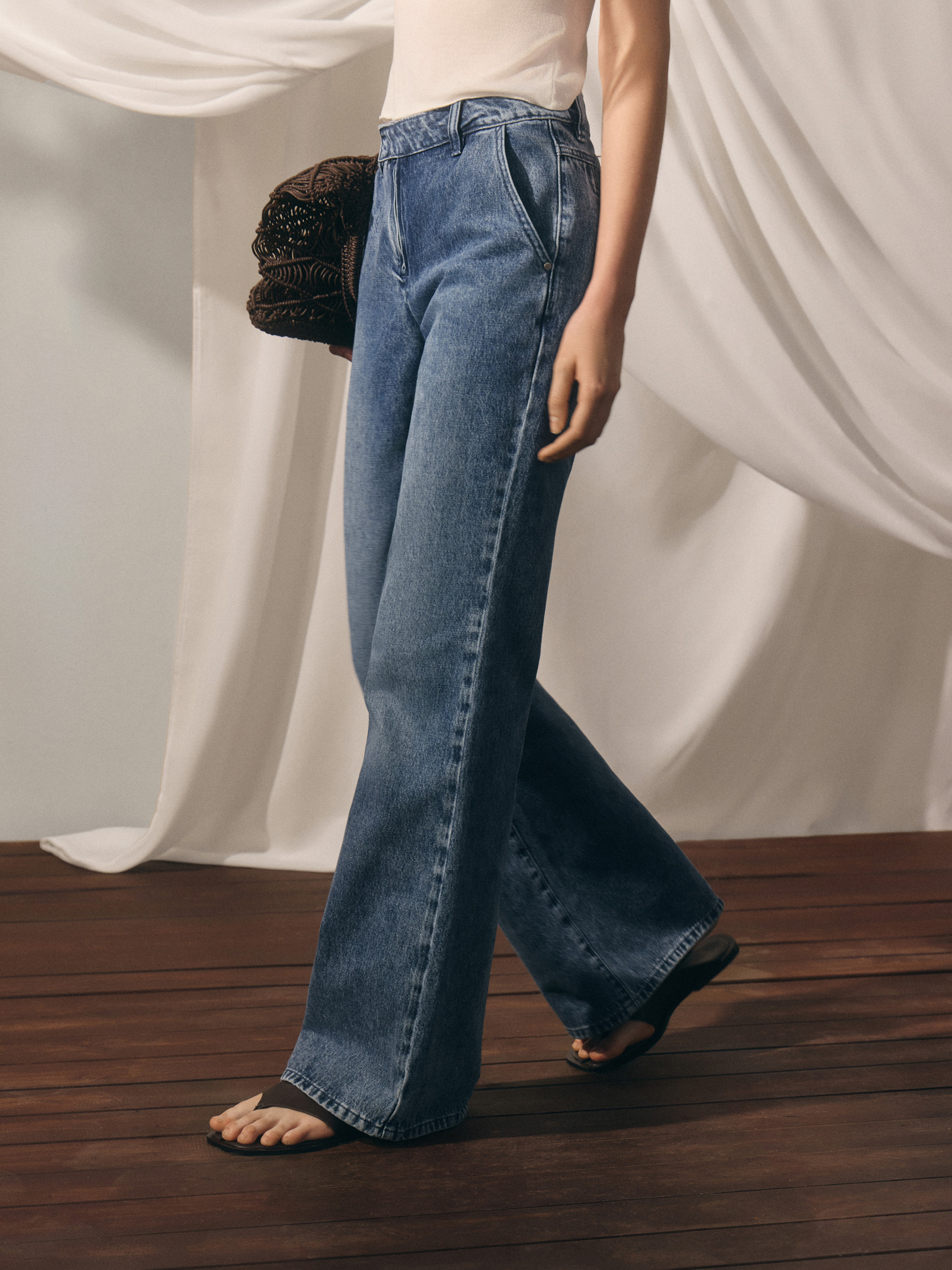 Flared denim jeans with distressed details