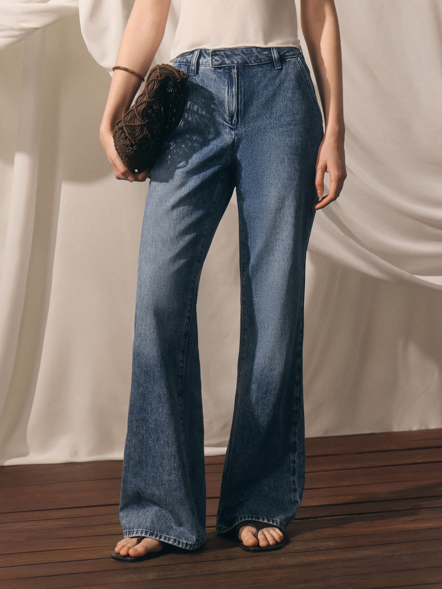 Flared denim jeans with distressed details