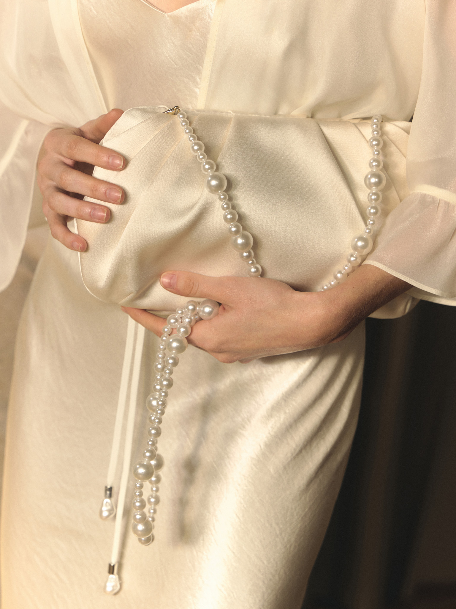 Satin clutch with pearl thread