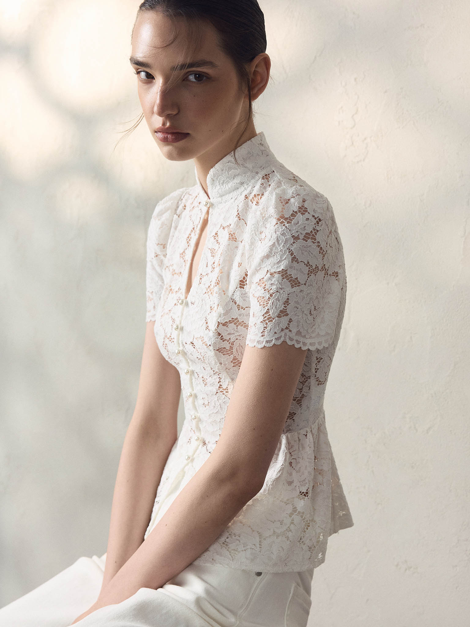 Blouse ajustée en guipure, avec encolure en goutte d'eau et basque