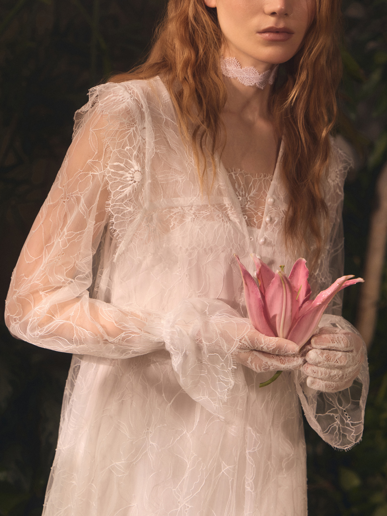 Lace cape with pearlescent button fastening
