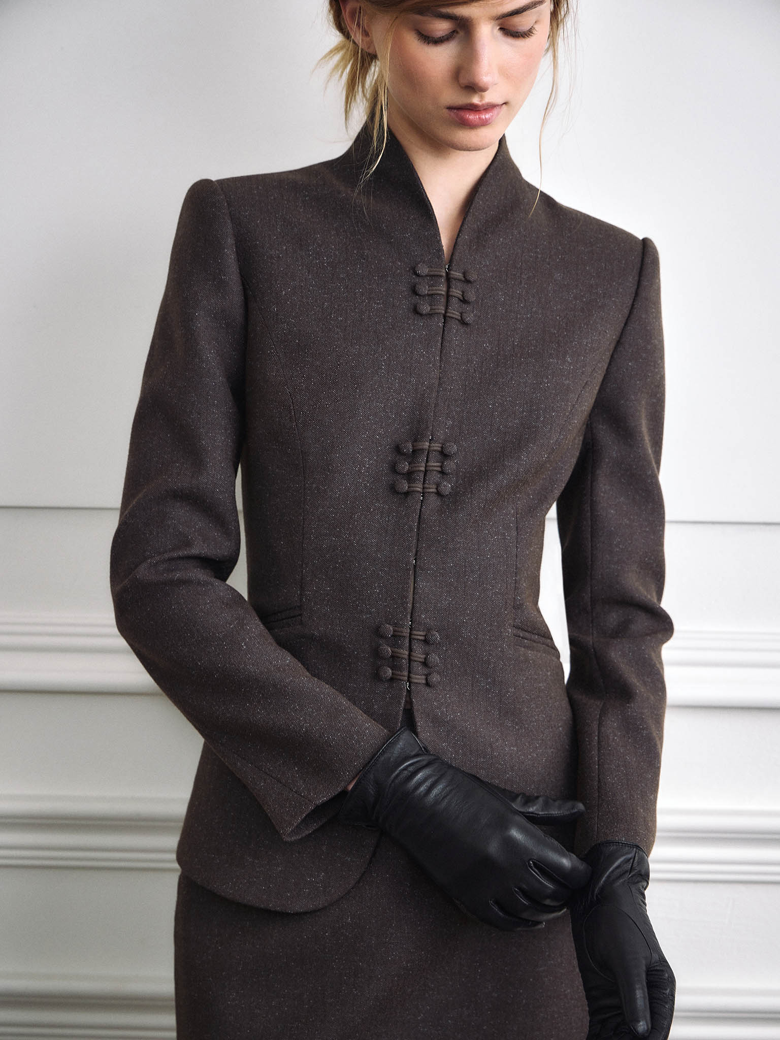 Single-breasted jacket with a high collar and hidden fastening 